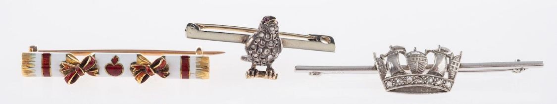 A group of three brooches, to include a bird designed brooch,