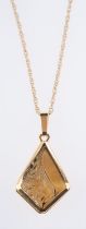 A 9ct yellow gold locket pendant, of 'kite' shape with foliate engraving, measuring 2.70cm x 1.
