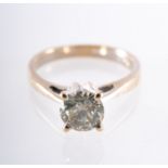 A single stone solitaire ring, high set with a brilliant-cut diamond in a four claw setting,
