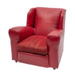 A red faux leather covered wingback armc