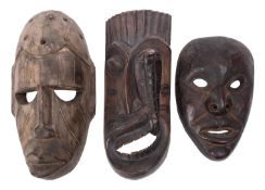 Three carved wood tribal masks, 20th cen