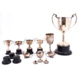 A collection of silver trophies, various