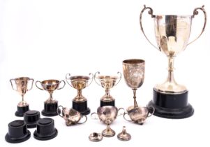 A collection of silver trophies, various