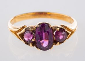 An antique three stone ring, set with tw