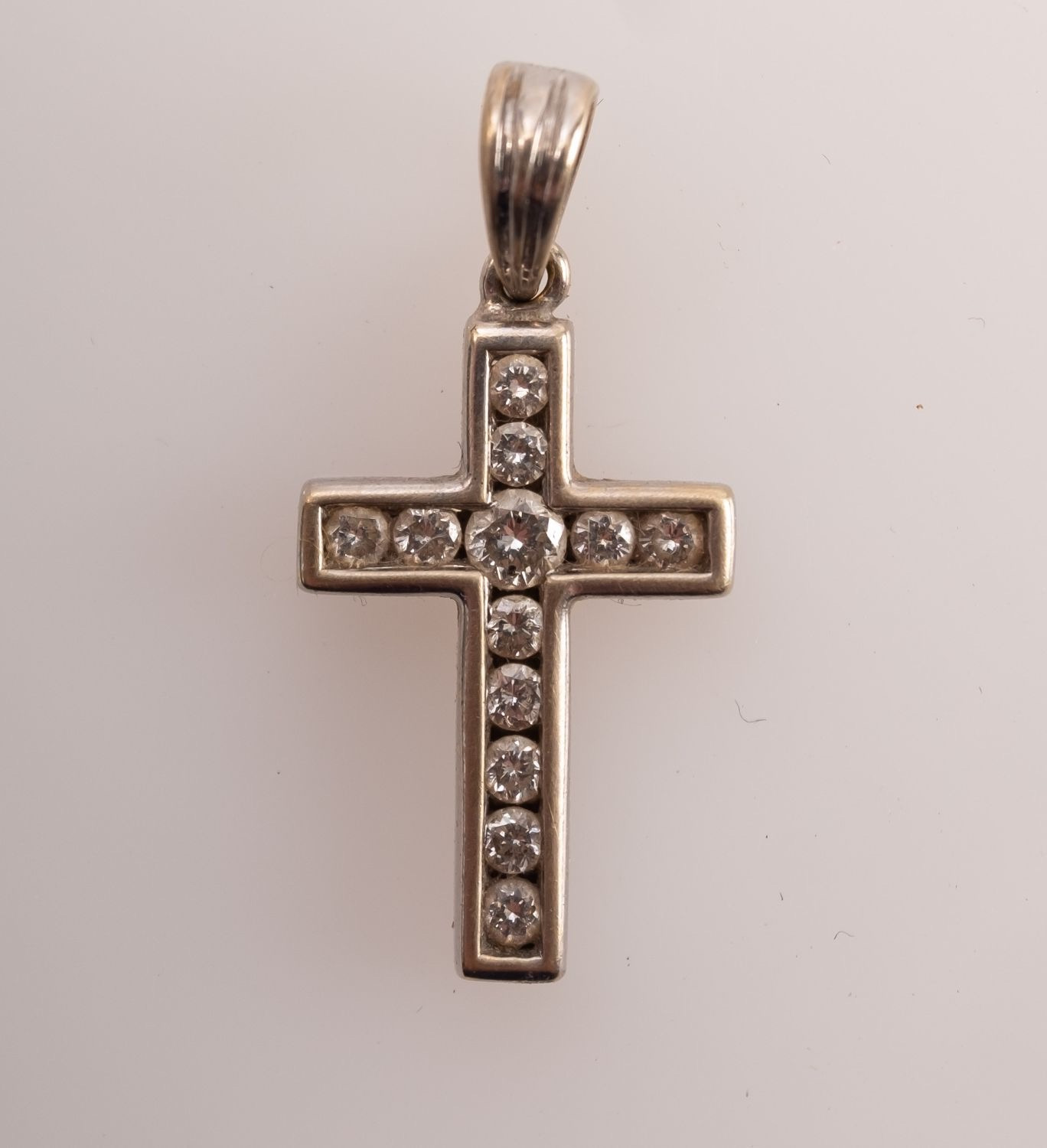 A diamond set cross in 18ct white gold,