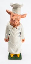 A reproduction cast alloy doorstop in the form of an anthropomorphic pig butcher, 58cm high.
