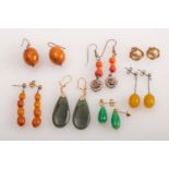 A group of earrings in amber, jade, mic