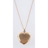 A heart shaped locket, with foliate engraving, marked to verso 9ct front & back,