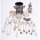 A group of silver items, comprising of; three napkin rings, a pepperette,