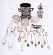 A group of silver items, comprising of; three napkin rings, a pepperette,