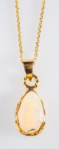 An opal pendant, a pear shaped clear opa