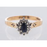 A 9ct yellow gold cluster ring, centrall