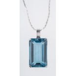 A blue topaz pendant, claw set with a re