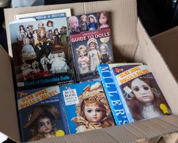 Four boxes of books and auction catalogues relating to dolls