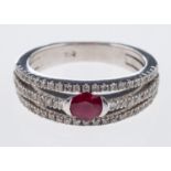 A diamond and ruby ring the central oval