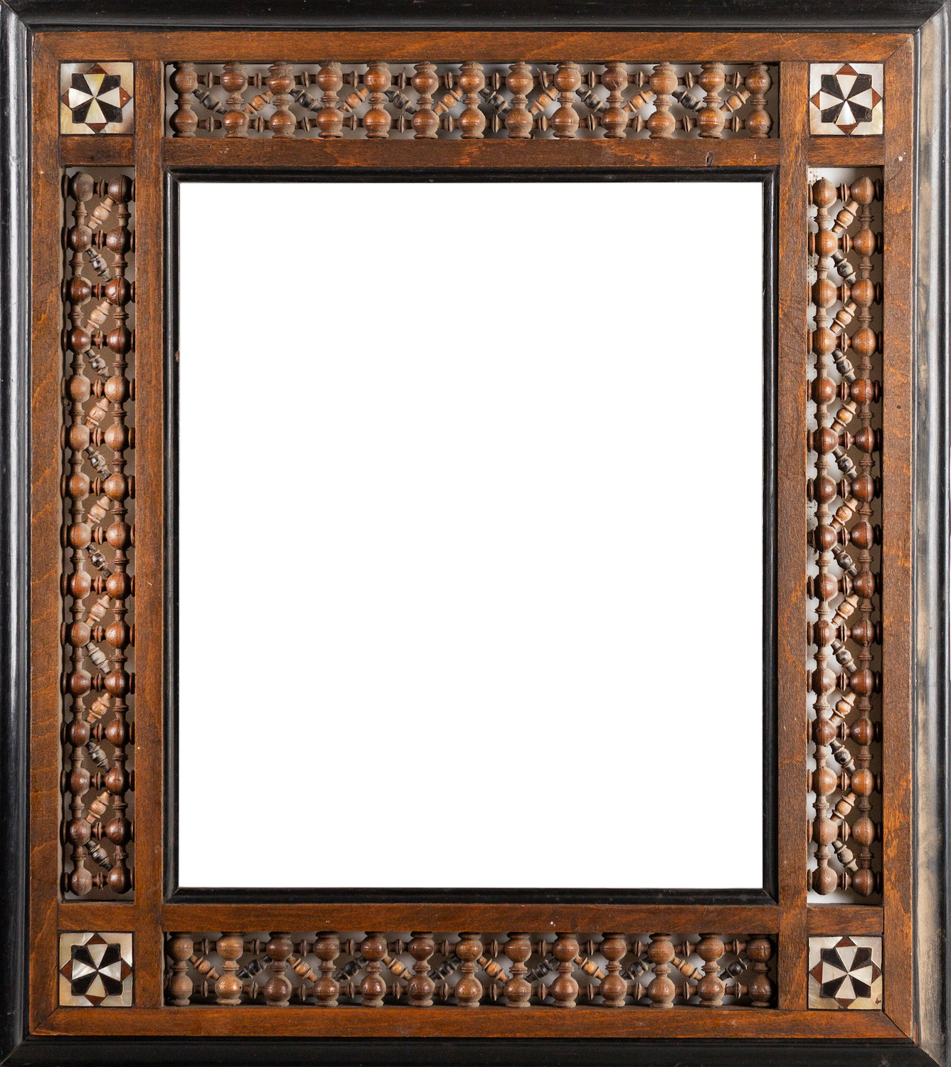 An Arts and Crafts Moorish frame with Mashrabiya turnings and bone inlay. 47 x 41cm, 27 x 20.