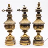 A set of three late Victorian brass electric table lamps,
