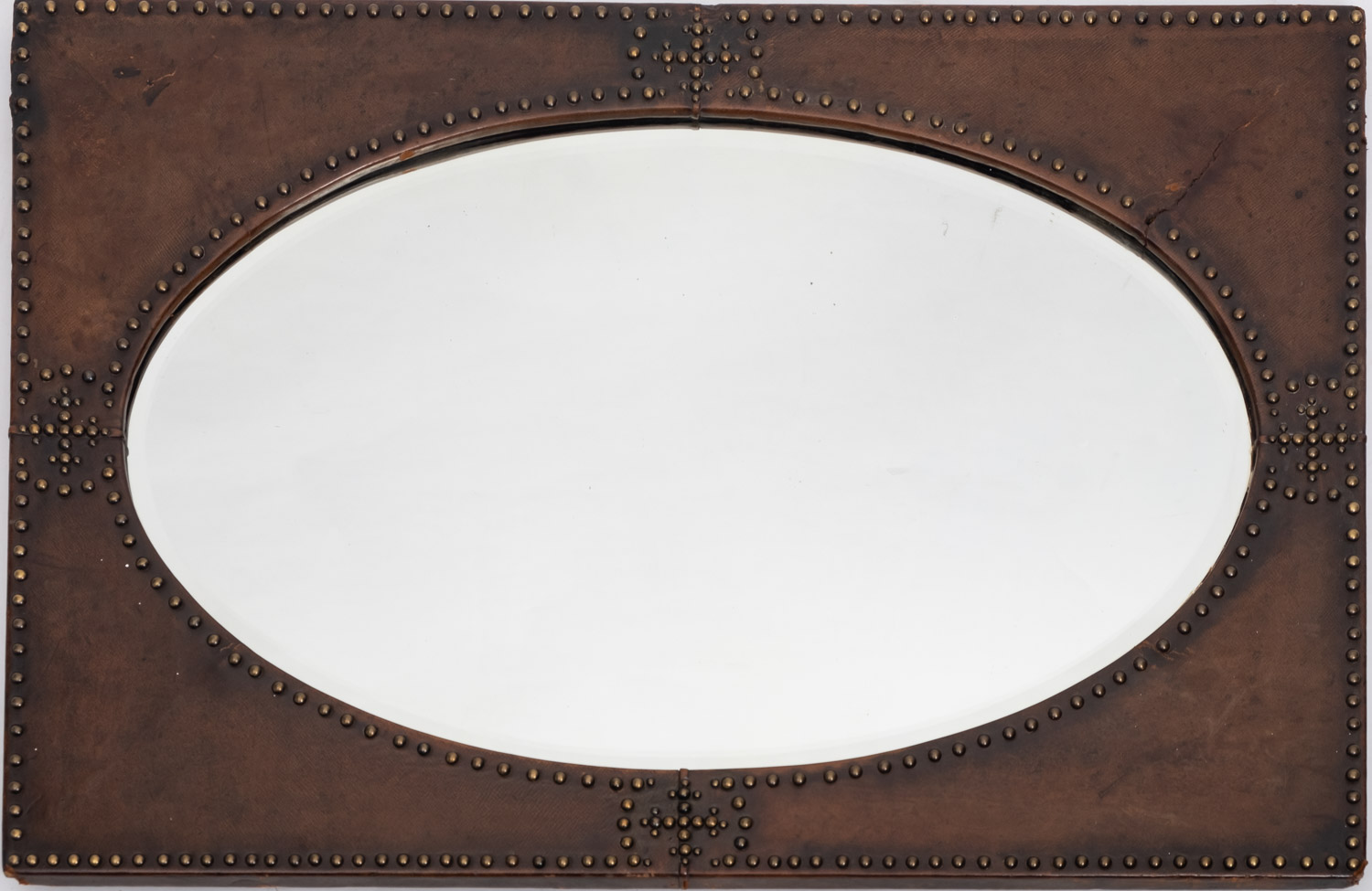 A studded leather veneered wall mirror, in Arts & Crafts taste,