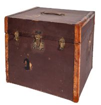 A canvas covered and leather bound square travelling box with brass lock and hinges,