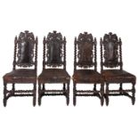 A set of four Victorian carved oak and leather upholstered side chairs in Charles II style,