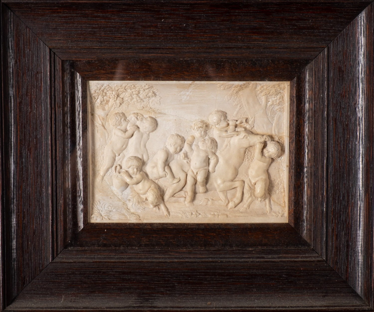 A set of five plaster reliefs of cavorting amorini, late 19th Century, framed and glazed.