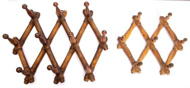 A set of Victorian articulated turned and stained beech hanging pegs,