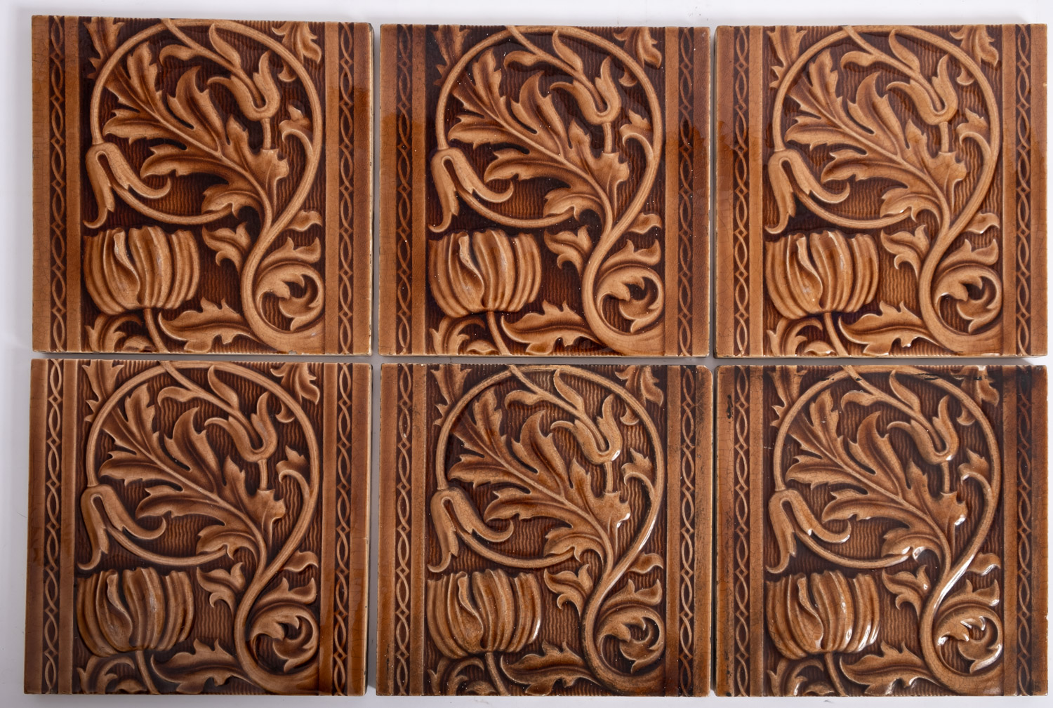 A set of six Minton's brown glazed pottery square tiles,