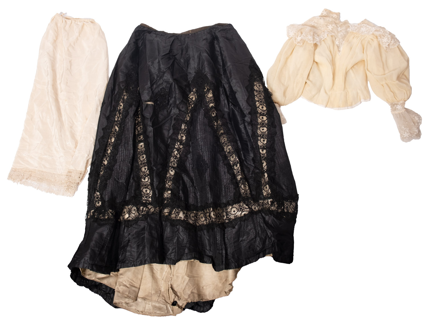 An Edwardian black silk and lace skirt, together with a white cotton and lacework blouse,