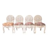A set of four Anglo Indian carved hardwood and upholstered side chairs,