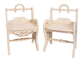 A pair of Edwardian later cream painted stools with low turned rail backs and solid seats,