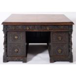 A Victorian carved oak pedestal desk, late 19th Century,