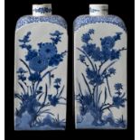 A pair of Japanese Arita blue and white square-section bottles (tokkuri), circa 1700,