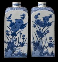 A pair of Japanese Arita blue and white square-section bottles (tokkuri), circa 1700,