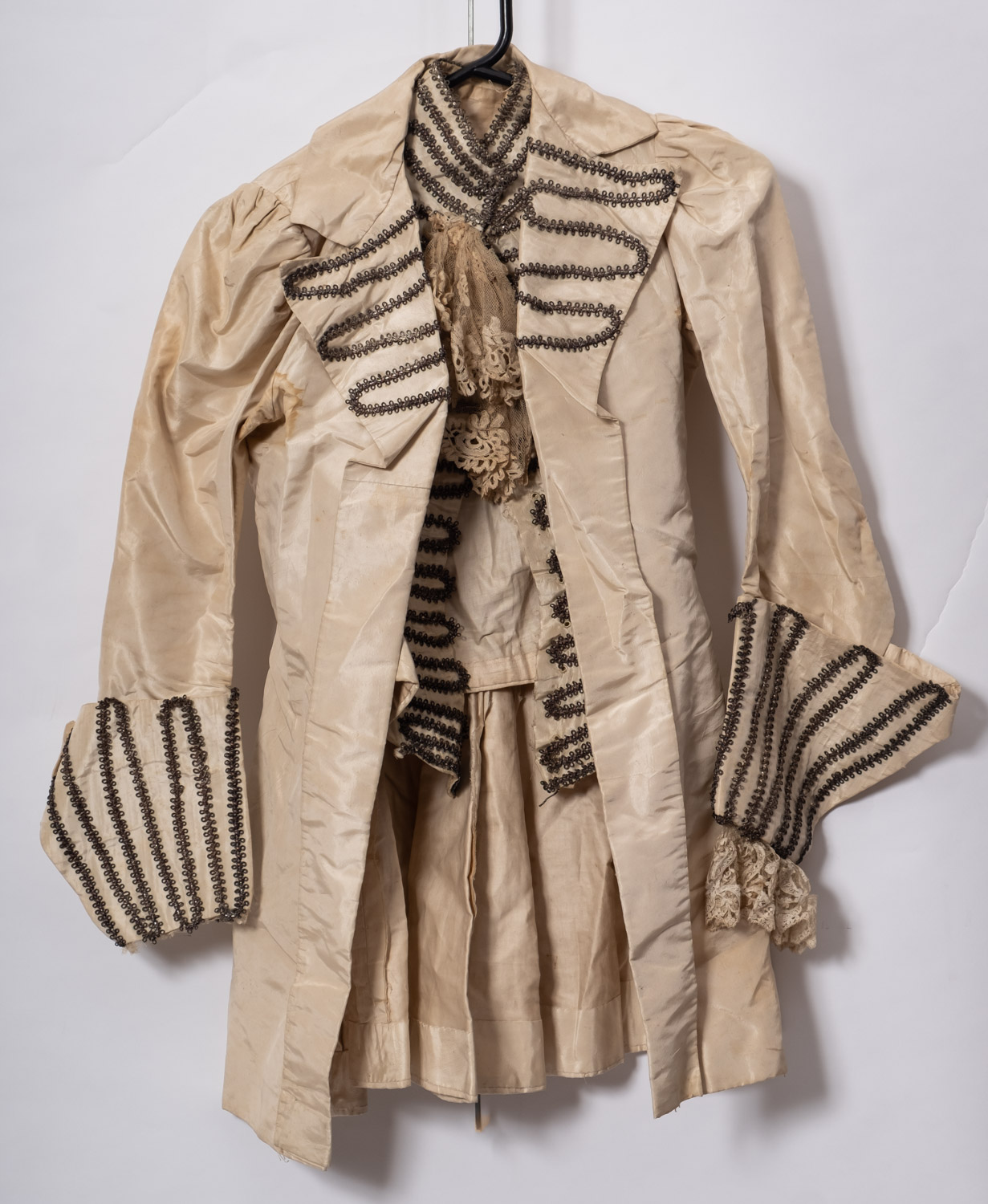 A 19th century white silk jacket and matching waistcoat together with a purple silk skirt and
