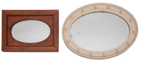 A repousse copper framed oval wall mirror in Arts & Crafts style,