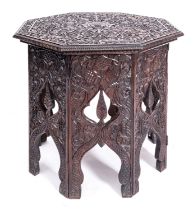 An Anglo Indian carved hardwood octagonal occasional table on integral stand,
