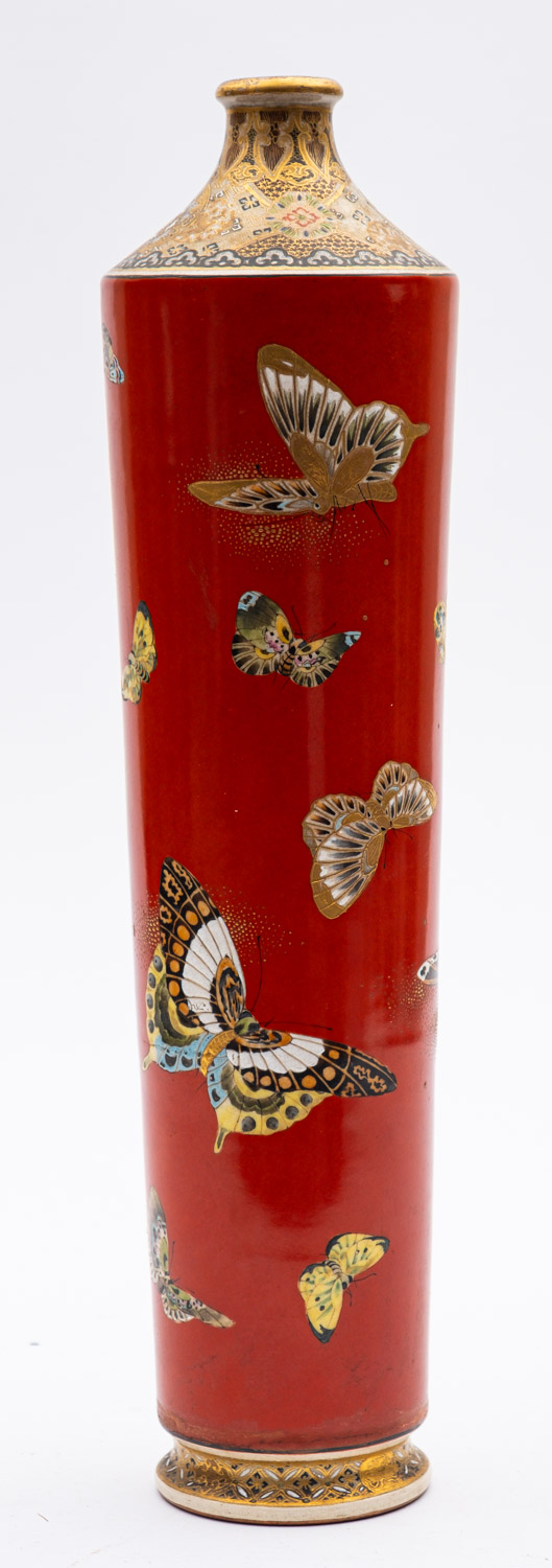 A Satsuma pottery vase of tapering cylindrical form, the iron red body enamelled with butterflies,