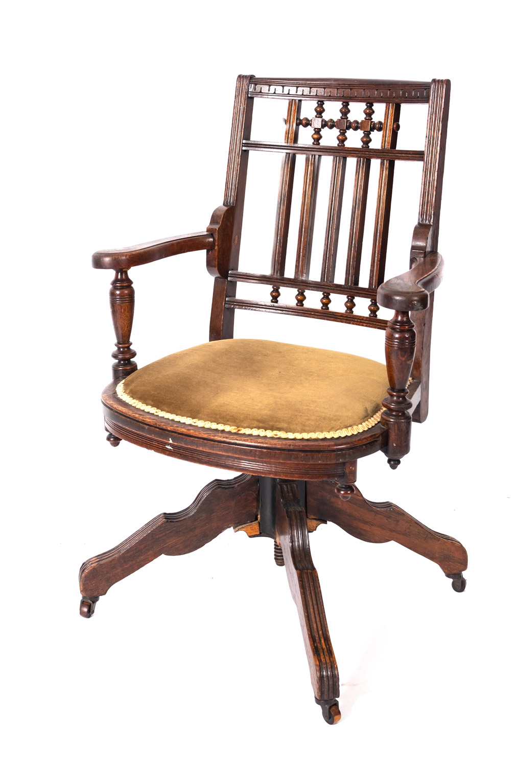 A Victorian oak revolving desk elbow chair, circa 1900,