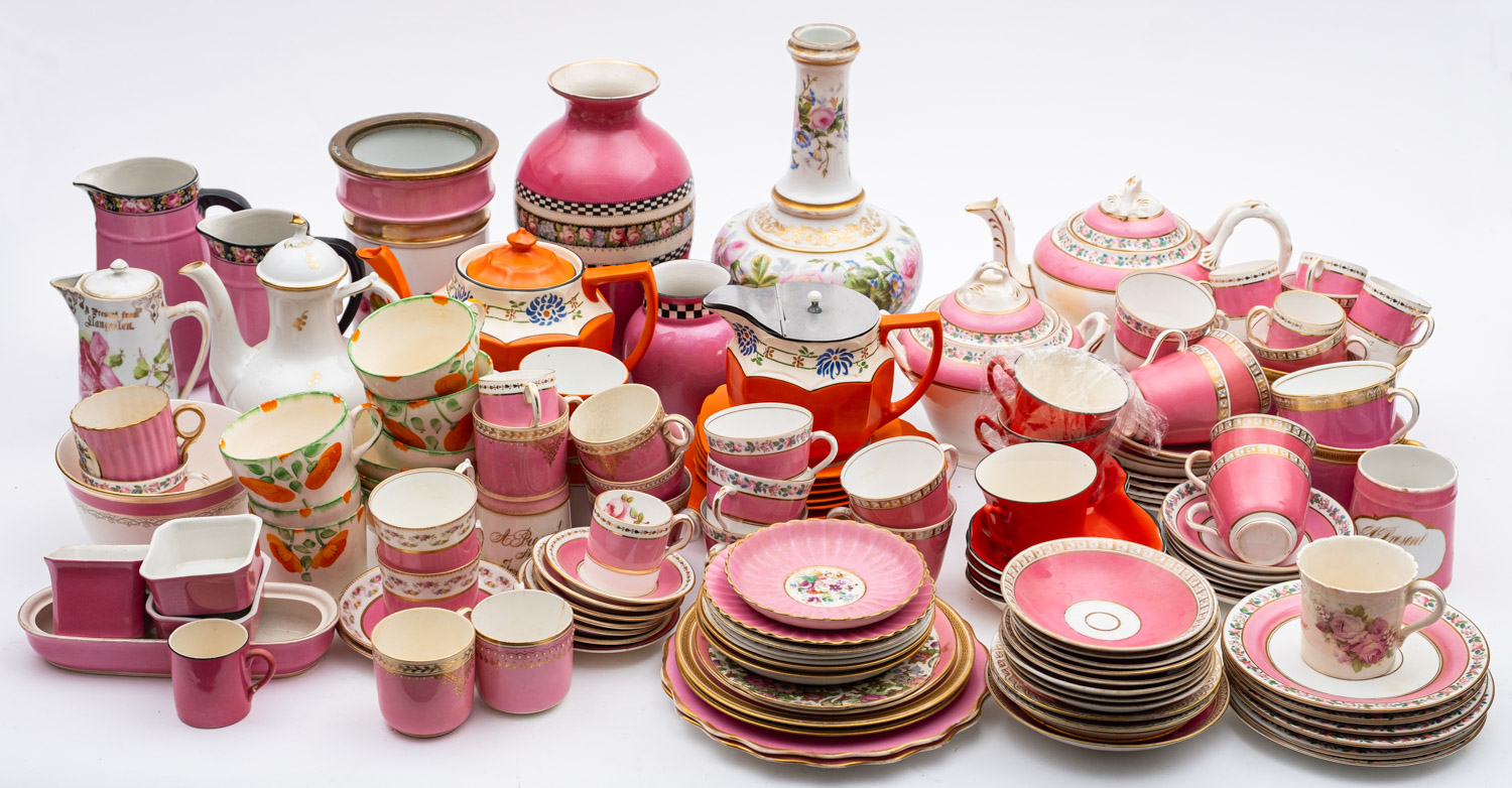 A collection of 19th century and later tea wares, predominately in pink and orange glazes.