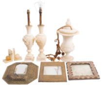 A pair of alabaster urn table lamps with raised flower heads and foliage on square bases, 57cm high,