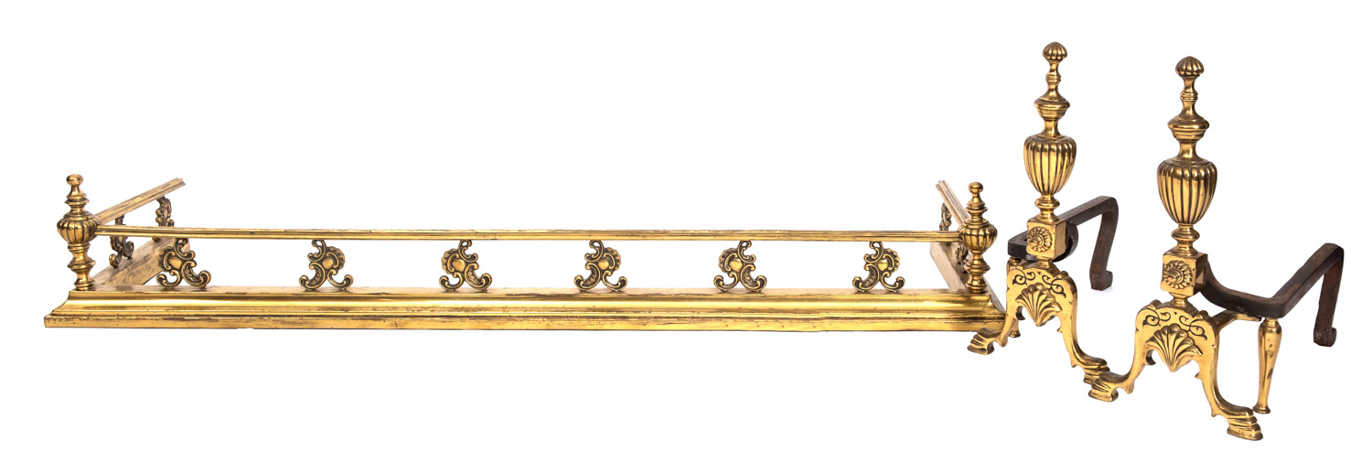 A brass fender, circa 1900, the moulded top rail with lobed urn finials at the corners,