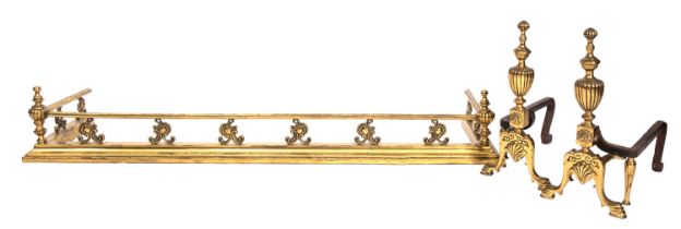 A brass fender, circa 1900, the moulded top rail with lobed urn finials at the corners,