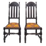A pair of carved oak side chairs in Charles II style, circa 1900,