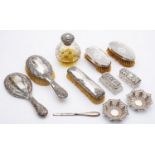 A group of silver mounted dressing table items including: a cut glass globular scent bottle,