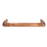 An Arts and Crafts copper rectangular fire kerb, circa 1900, with stylised decoration,