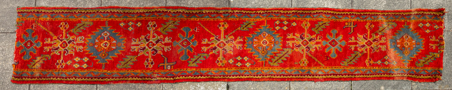 A Turkey runner of traditional design and colours with five geometric medallions, 342cm x 90cm,