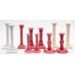 Five pairs of white and pink glazed candlesticks and one single candlestick.