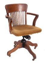 A Edwardian oak revolving office desk arm chair, circa 1910,