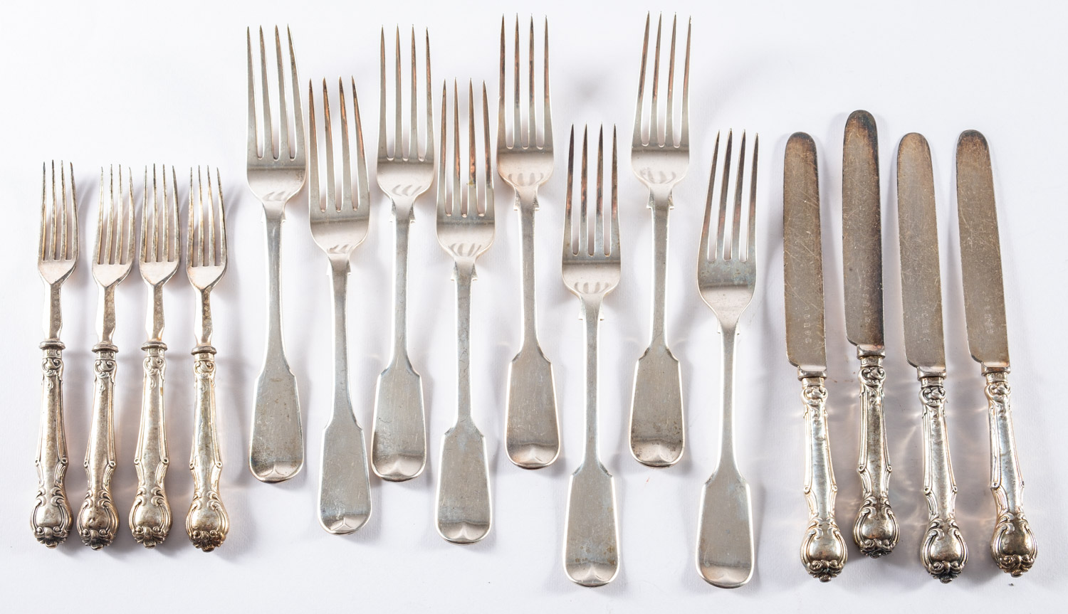 A set of five William IV silver fiddle pattern table forks, London 1834, two others, London 1819,