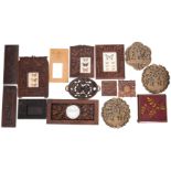 A collection of assorted relief carved wood items,